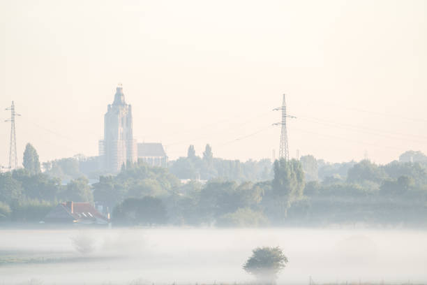 landscape on an early beautiful morning with some misty houses among the houses
