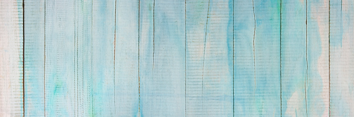 Old blank textured blue and white, turquoise-colored watercolor effect on wooden, teak timber board background with lots of cracks and scratches that shows grunge effects, a great backdrop for copy space.