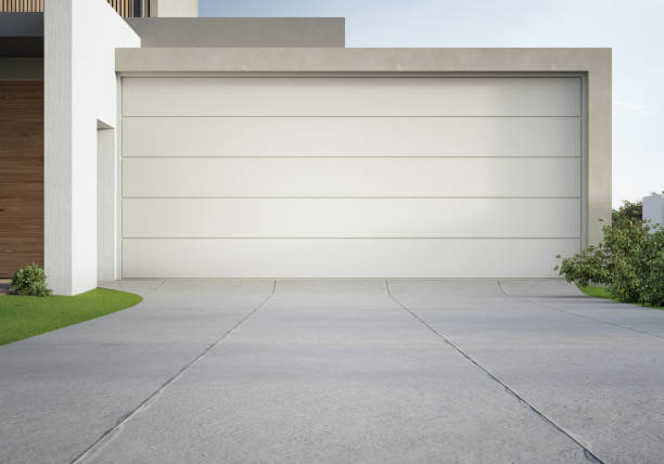 Modern house and big garage with concrete driveway.
