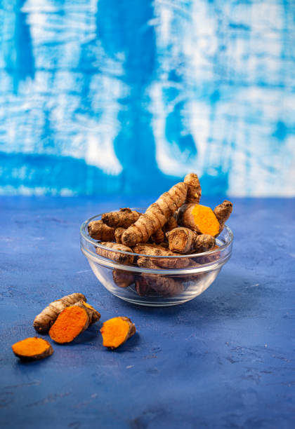 istock turmeric powder in jar dish on blue background 1175837118