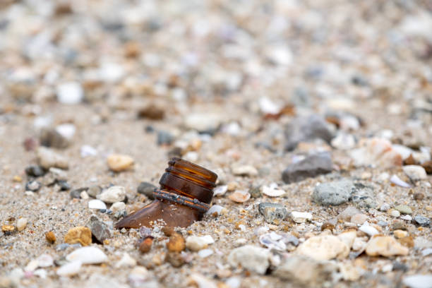 Closeup image of broken glass bottles on the beach