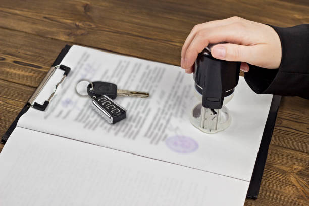 istock Buying a car, hand, keys, contract, seal, pen 1175839486