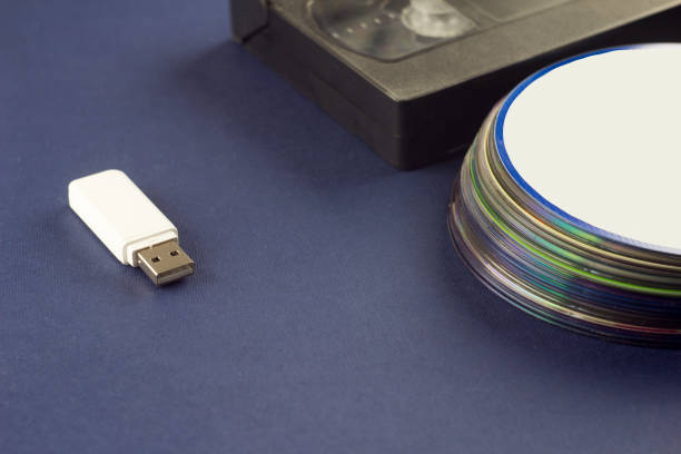 istock White flash drive on a blue background video cassette and compact discs 1175839516