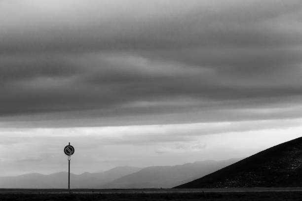 istock Road sign against a moody sky background with big clouds 1175840102