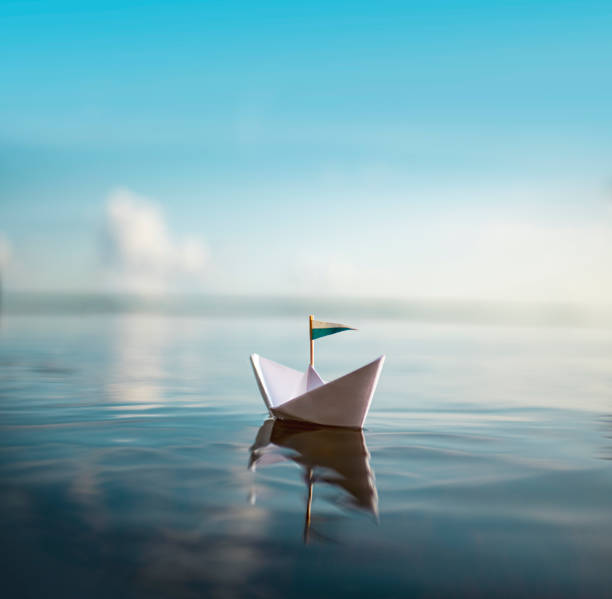 istock Paper ship on Quiet Lake 1175840725