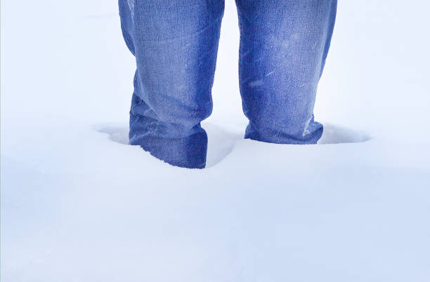 istock Man stands in the snow knee-deep, close-up 1175841919