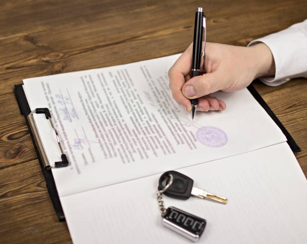 istock Buying a car, hand, keys, contract, seal, pen 1175841991