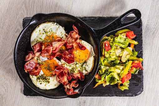 Sunny side up style eggs and bacon breakfast