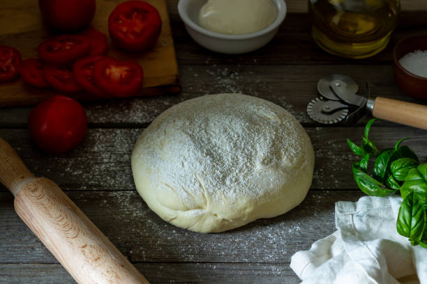 istock Ingredients for pizza. Dough, tomatoes, mozzarella, basil. Italian cuisine. 1175842194