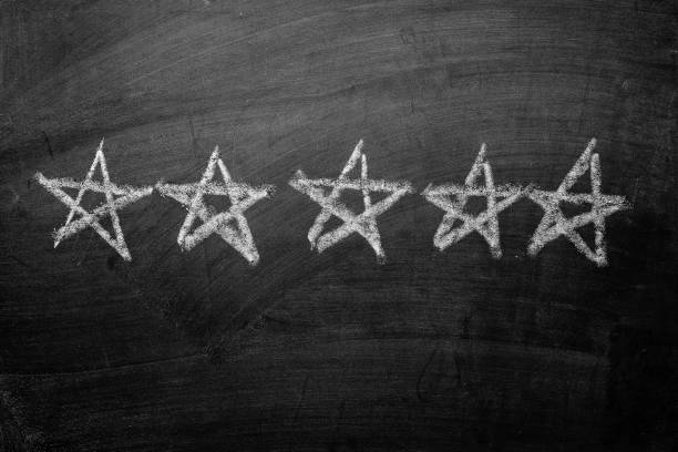 istock Five white chalk stars drawn on a blackboard 1175847948