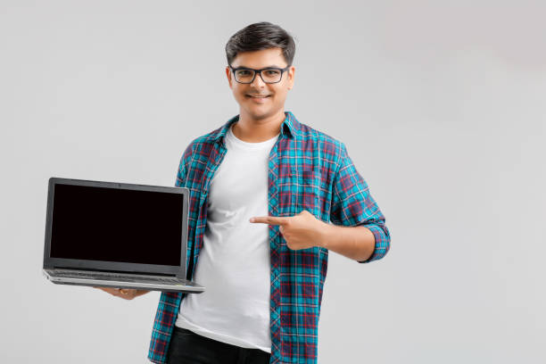 istock Young Indian / Asian man showing laptop screen 1175850971