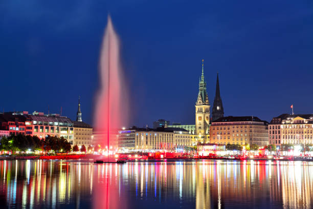 Panoramic view of Binnenalster (Inner Alster Lake) with Jungfernstieg and Rathaus in the background at night, Germany