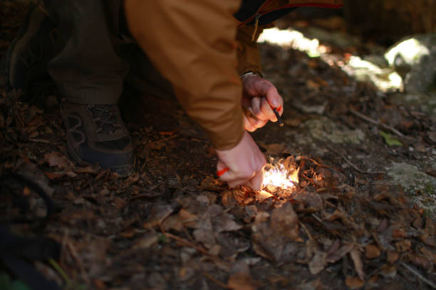 istock Person tries to make a fire with a flint 1175854324
