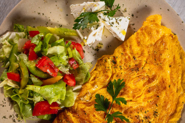 istock Omelette with cheese and fresh salad 1175855844
