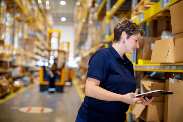 istock Woman examining boxes on warehouse racks 1175858202
