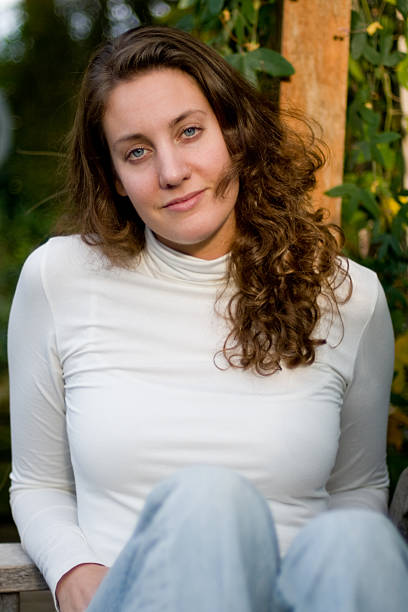 istock Young woman sitting on bench 117586035