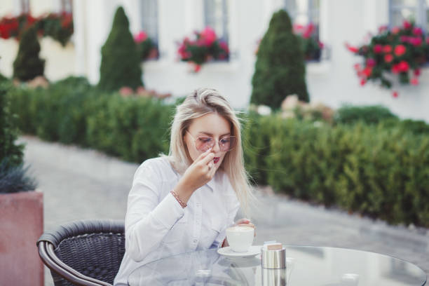 istock woman in the cafe sits at a table 1175860477