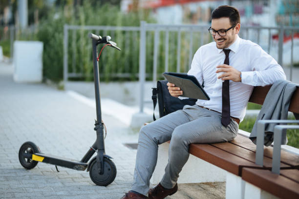 istock Businessman using digital tablet in the city park after scooter riding 1175862389