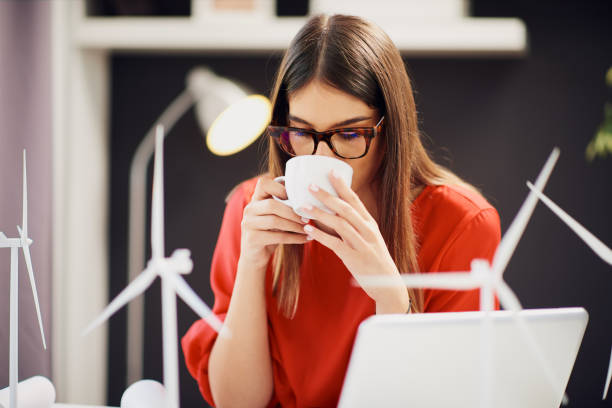 istock Woman drinking coffee in office. 1175862709