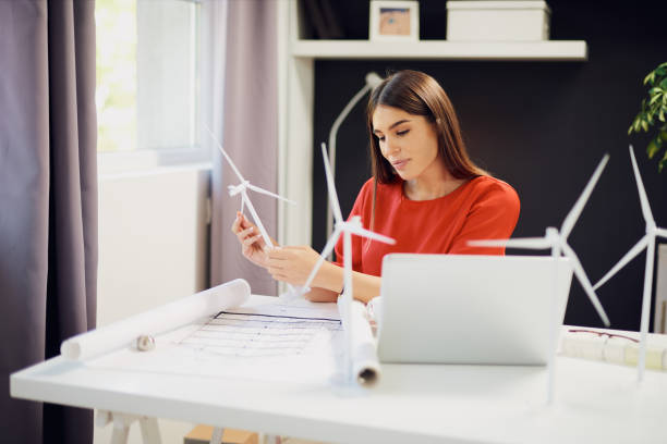 istock Businesswoman holding windmill model. 1175864179