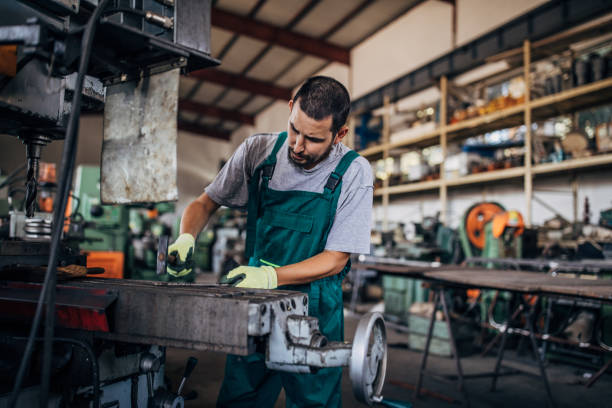 istock Young man working in metal factory 1175865407