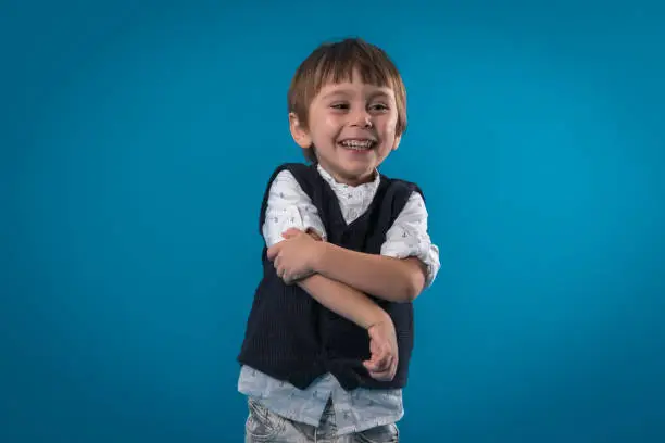Portrait of smiling boy over colored backgrounds