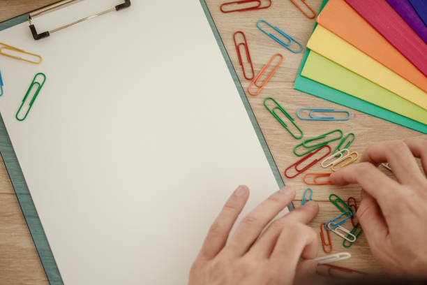 istock Businessman with multi colored paper clips 1175867044