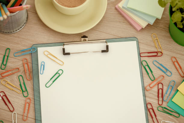 istock Clipboard with blank paper, multi colored paper clips 1175867372