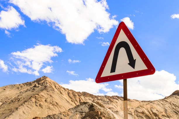 Curves ahead highway sign in Leh Ladakh, Jammu and Kashmir, India. Curves ahead highway sign in Leh Ladakh, Jammu and Kashmir, India. Traffic sign with mountain and blue sky background. moonland stock pictures, royalty-free photos & images