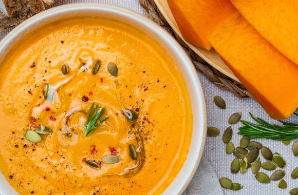 istock Delicious pumpkin cream. Home and rustic appearance. Includes fresh pumpkin, seeds and rye bread. Aerial view. 1175868820