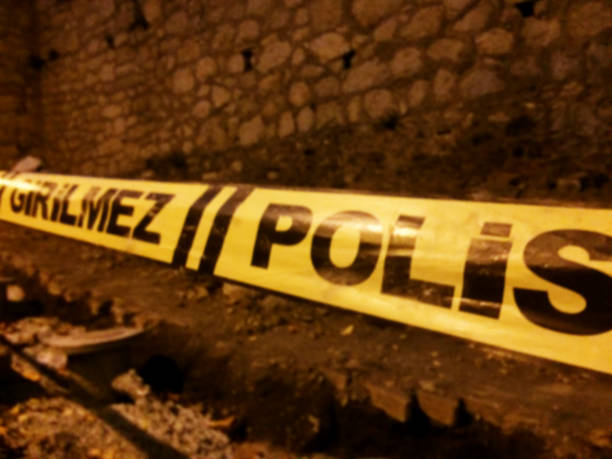 istock Yellow caution do not enter tape at a crime scene 1175872315