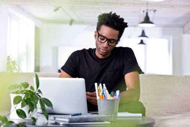 istock Confident businessman sitting with laptop on sofa 1175872634