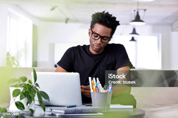 Confident Businessman Sitting With Laptop On Sofa Stock Photo - Download Image Now - 30-34 Years, Adult, Adults Only