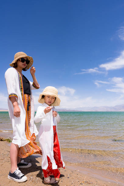istock mother and daughter by the lake side 1175872638