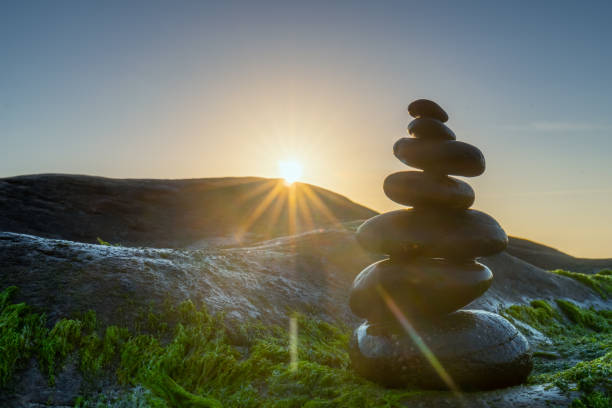 istock Stacked Pebbles art on mossy rocks welcomes beautiful new day 1175872882