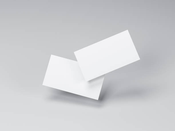 istock Two white Business Cards Mockup flying in gray studio 1175875429