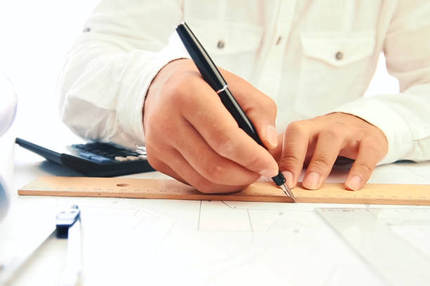 istock Work on a drawing of diagram by an engineer. Engineer's hand over the drawing. 1175877972