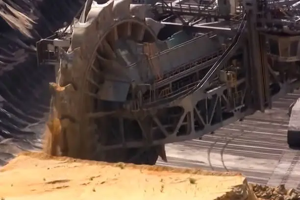 The work of a bucket wheel excavator in a quarry. Ore mining in a quarry.