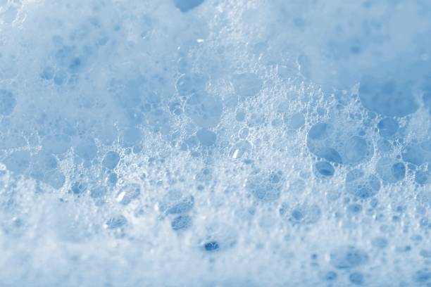istock Backgrounds of blue foam soap bubbles on blue background. Laundry detergent, suds textured pattern. White soap suds macro view. 1175878911