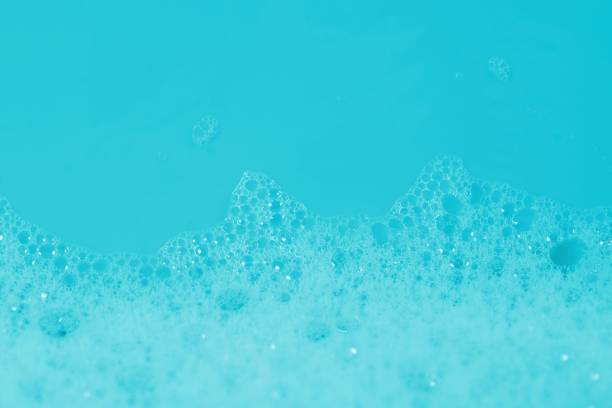 istock Backgrounds of blue foam soap bubbles on blue background. Laundry detergent, suds textured pattern. White soap suds macro view. 1175878968