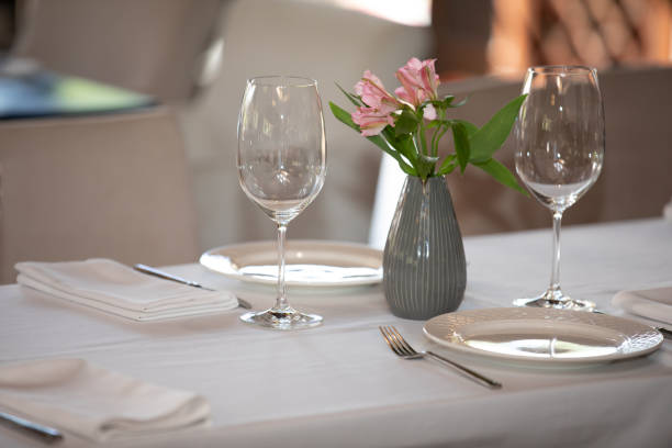 istock Served table in restaurant, focus on near glass and plate 1175883149