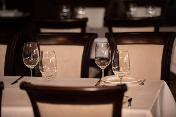 istock Served table in restaurant, focus on near glass and plate 1175883335