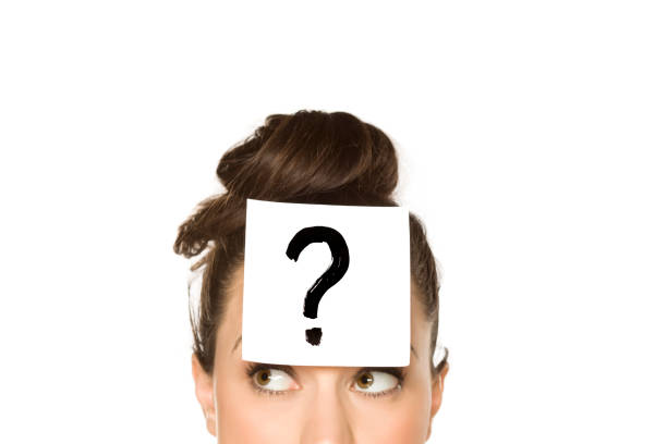 istock a young confused woman with a drawn question mark on paper on a white background 1175888285