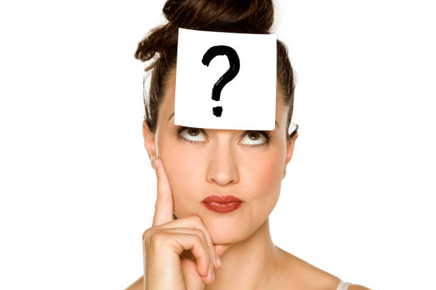 istock a young confused woman with a drawn question mark on paper on a white background 1175888374