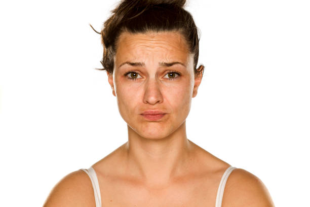 istock young unhappy woman without makeup on white background 1175888507