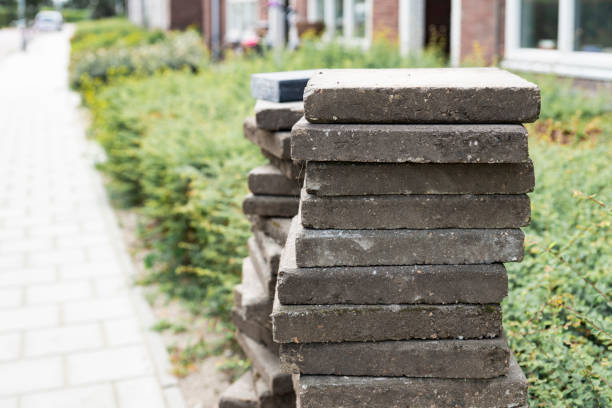 istock street road reconstruction, heap grey tiles for paving 1175888535