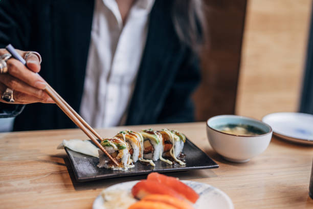 Mature man in sushi bar Mature man eating sushi in sushi bar chinese ethnicity china restaurant eating stock pictures, royalty-free photos & images