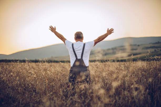 istock The farmer views the wheat farming field 1175893032