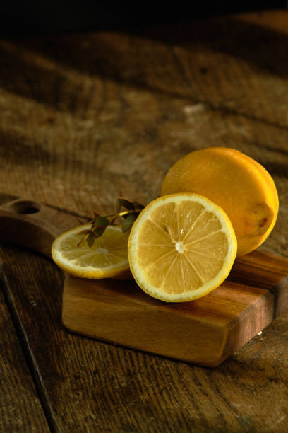 istock Sliced lemon and eucalyptus lie on a wooden board. 1175895056