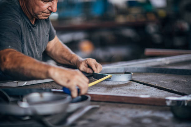 istock Senior man working in factory 1175899339